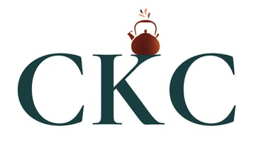 White background. Large dark green serif text: “Copper Kettle”. A small copper-coloured kettle icon with a steam flourish sits above the letter “K” in “Kettle”. Below, in smaller grey serif text, the word “CONSULTING” is centered.